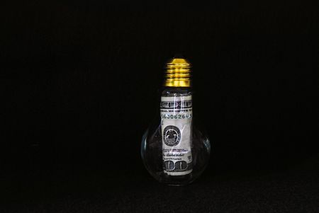 Hundred dollar bill in a light bulb.の写真素材