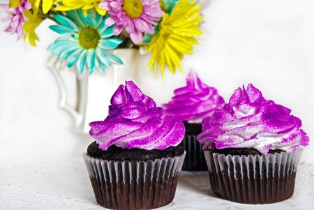 Fancy chocolate cupcakes with airbrushed frosting.の写真素材