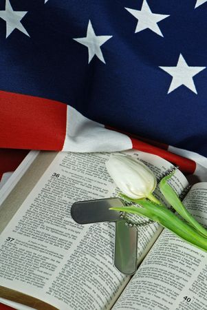 Tulip and military dog tags on an open Bible.の写真素材