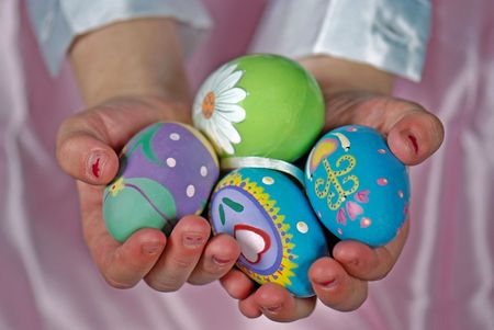 Little girl holding decorated Easter eggs.の写真素材