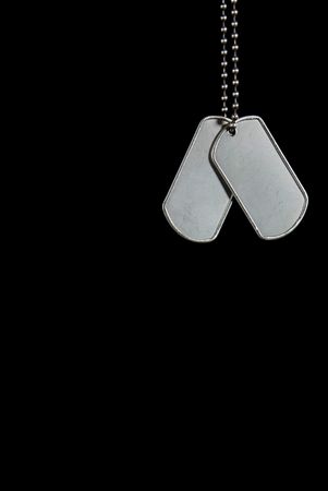 Military dog tags on a black background.の写真素材
