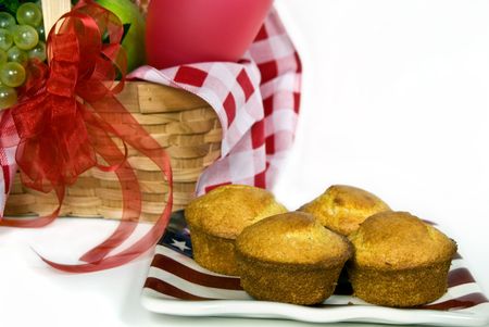 Corn muffins on flag plate with picnic basket.