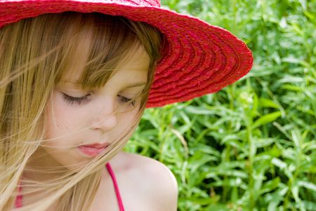 Little girl wearing a summer hat.の写真素材