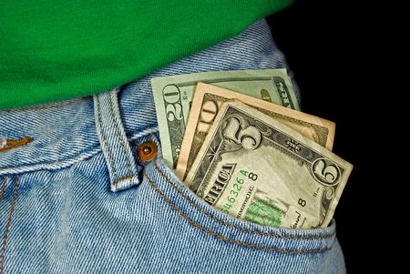 Loose money in front pocket of blue jeans.