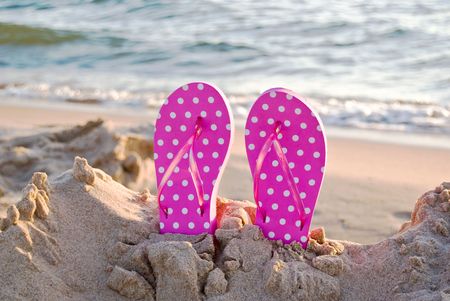 Flip-flops stuck in sand.の写真素材