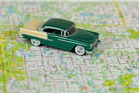 Vintage car on a road map.の写真素材