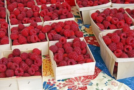 Raspberries in wooden produce boxes.