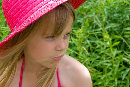 Little girl with a summer hat.の写真素材