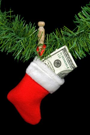 Hundred dollar bill stuffed in holiday stocking.の写真素材