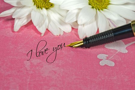 Love message with fountain pen and daisies.の写真素材