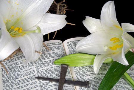 Easter lilies and nails on an open Holy Bible.の写真素材