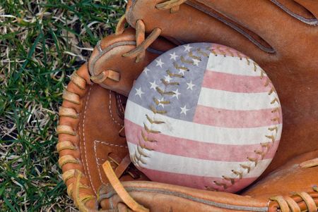 Flag design on softball in glove.の写真素材