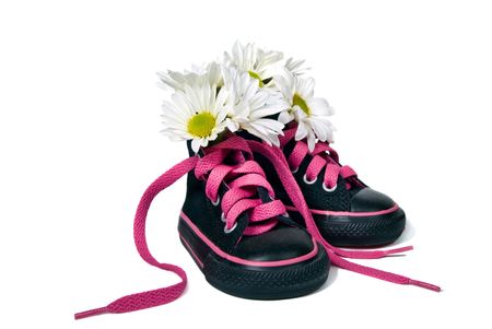 Daisy bouquet in girl's sneakers.の写真素材