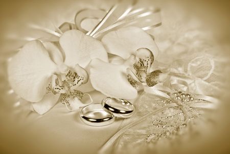 Orchid bridal bouquet with rings in sepia tones.の写真素材