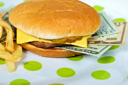 Money sandwiched in a cheeseburger.の写真素材
