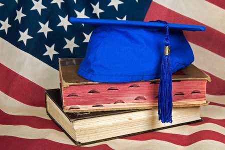 Flag background with graduation hat on books.の写真素材