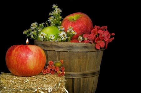 Candle in an autumn appleの写真素材