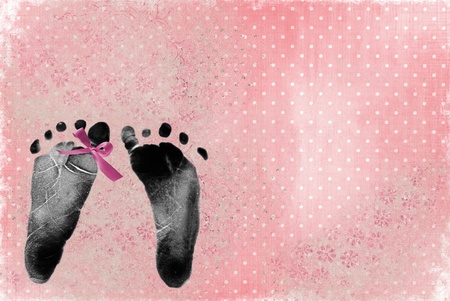 pink bow on newborn footprintの写真素材