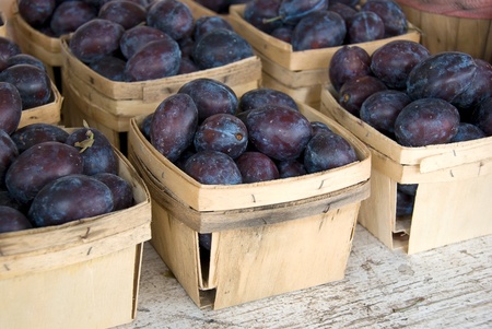 Ripe plums in produce boxes の写真素材