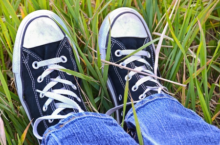 Pair of sneakers in tall grass の写真素材