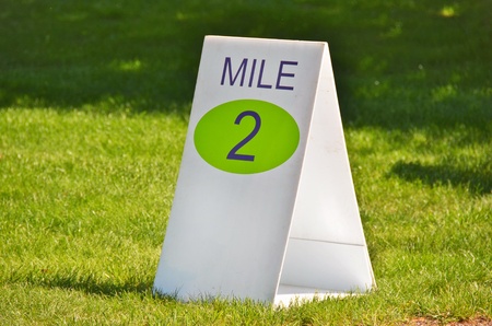 mile marker sign in grass for race