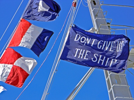 bold flags flying from sailboat mast