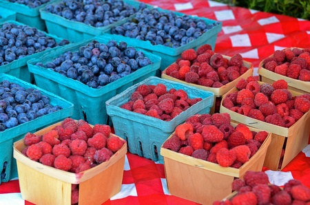 blueberries and raspberries in produce boxes