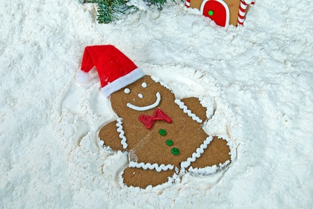 gingerbread man making a snow angel