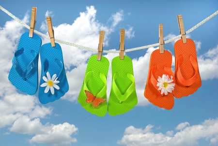 colorful flip-flops hanging on clotheslineの写真素材