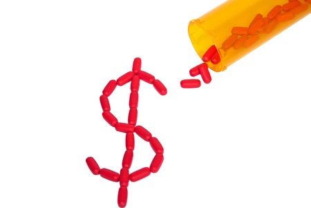 red pills with prescription bottle on white の写真素材