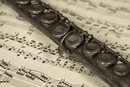 old flute on sheet musicの写真素材