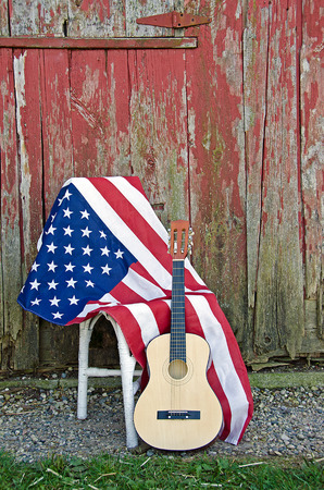 American flag with guitar by old red barnの写真素材