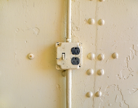 vintage electrical socket on metal wallの写真素材