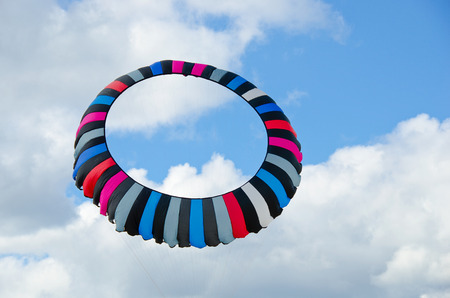 circular striped kite in summer skyの写真素材