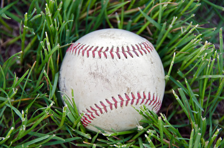 close up of a baseball in grassの写真素材
