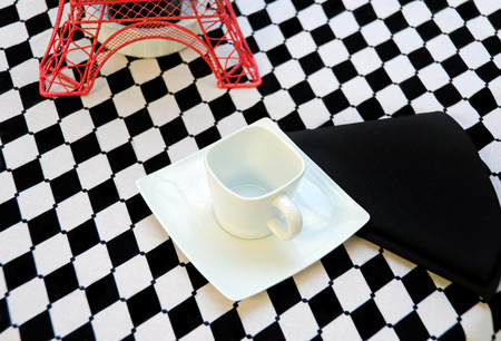 square coffee cup on checkerboard tablecloth with Eiffel towerの写真素材