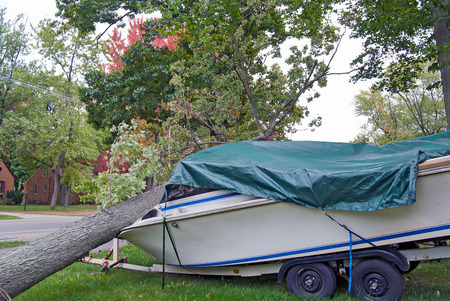 fallen tree on motor boat after a stormの写真素材
