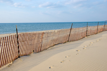 fence on vacant Lake Michigan beachの写真素材