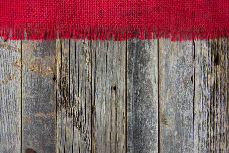 red frayed burlap border on rustic woodの写真素材