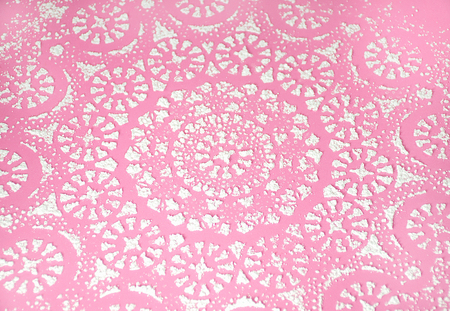ornate powdered sugar design on pinkの写真素材