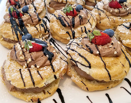French paris-brest pastry with chocolate mousse filling and fruit garnish