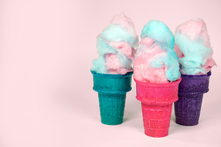 cotton candy in colorful ice cream cones isolated on pink backgroundの写真素材