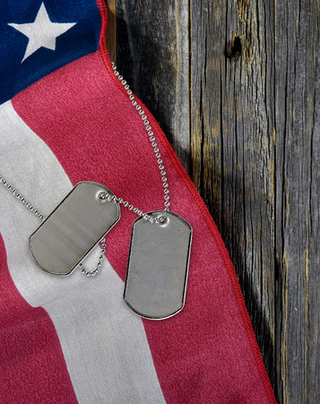 military dog tags and American flag on rustic woodの写真素材