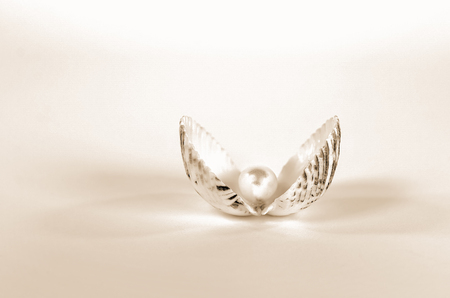 closeup of pearl in seashell with soft sepia abstract lightingの写真素材