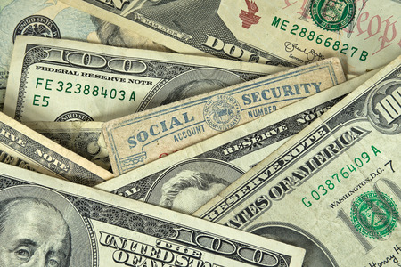 close up of social security card in paper money