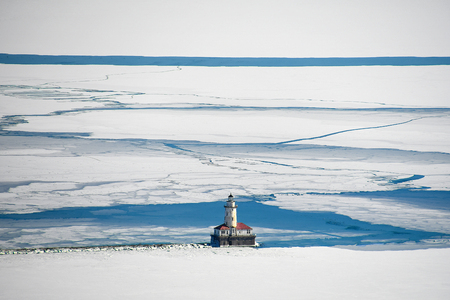 aerial view of Chicago lighthouse on Lake Michigan in ice and snowの写真素材