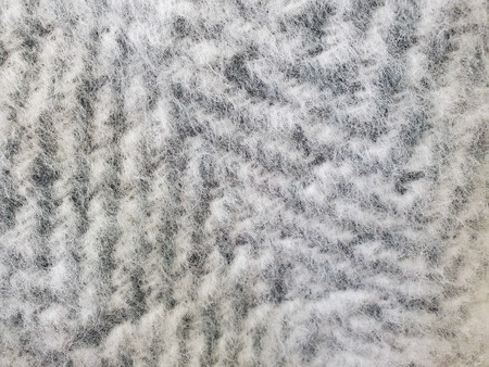 extreme close up of silver gray mohair zig zag knit pattern