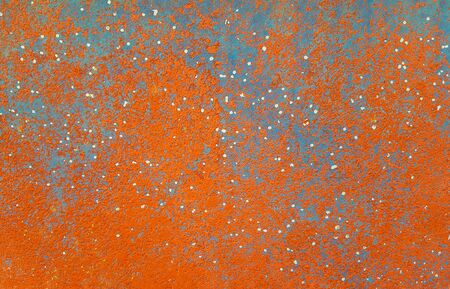 close up of bright orange and blue textured chipped paint background