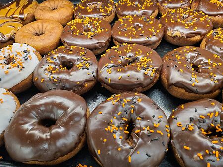 close up of Halloween sprinkles on chocolate donutsの写真素材
