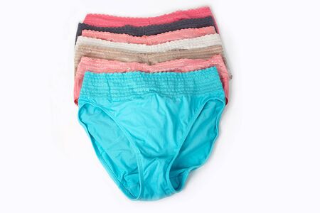 row of colorful silk women's panties on white background